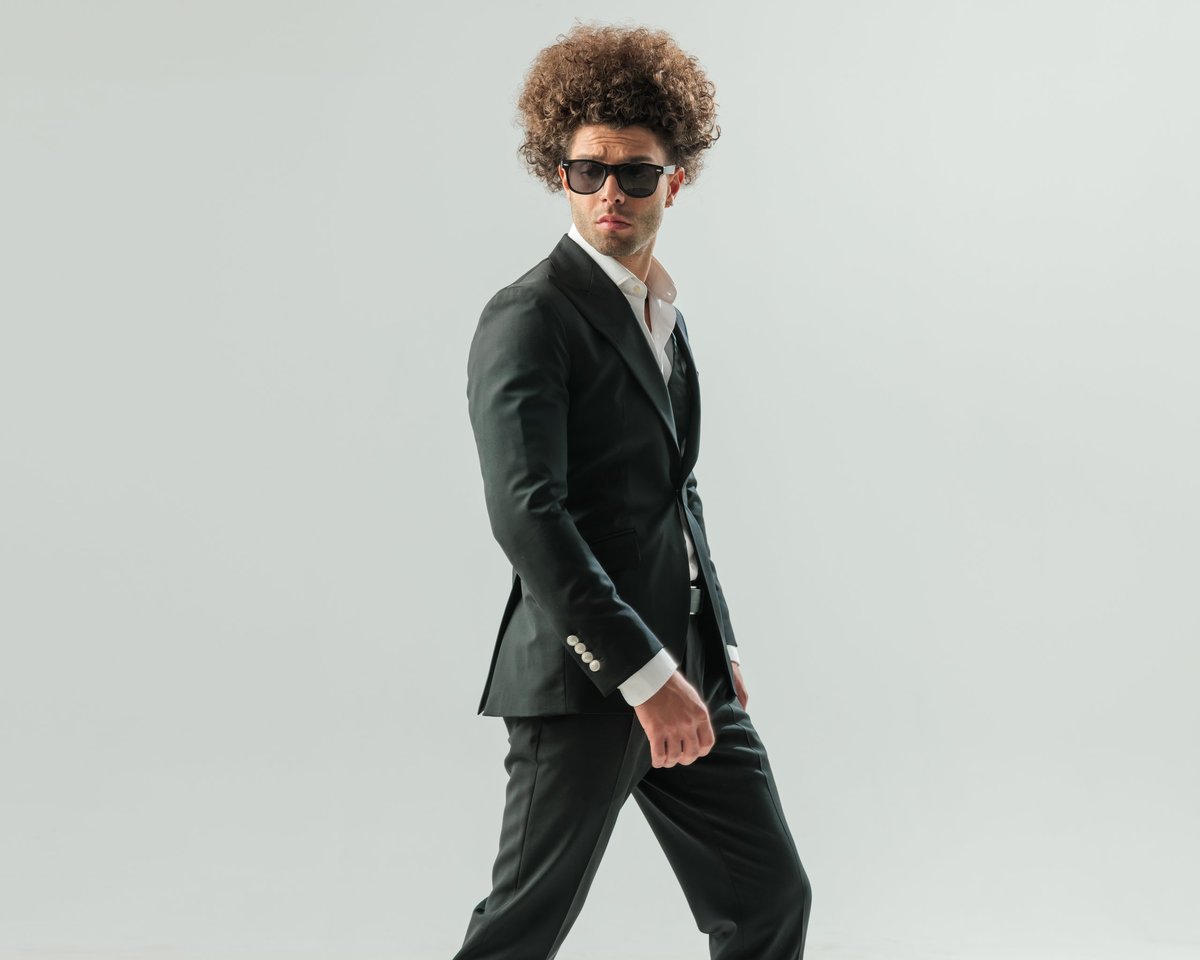Pimp Astro, Neon Beams producer and songwriter, in a tailored suit with sunglasses