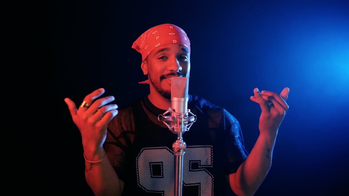 Donn Donn, Neon Beams artist and producer, performing in the studio under neon light